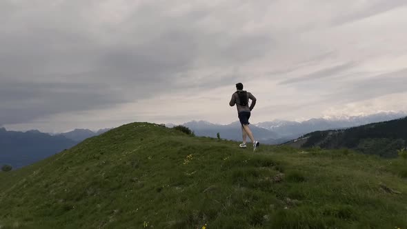 Tourist runner exploring mountains and jogging outdoors