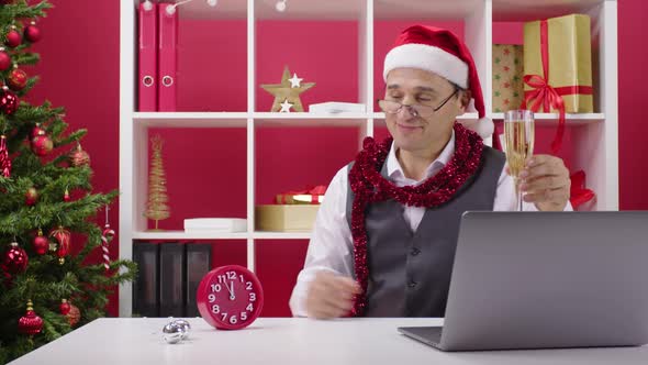 Corporate Employee Remotely Participates in Online Champagne Christmas Party