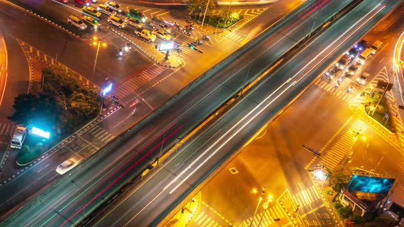 Time lapse of busy highway road junction in metropolis city center at night alt