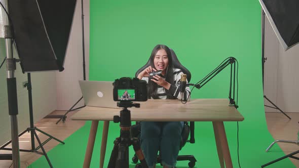 Camera Recording Asian Woman Reviewing Camera Len On Green Screen With Professional Light alt