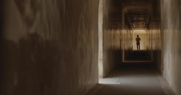 Silhouette of a man walking in corridor of Amber Fort in Jaipur, India alt
