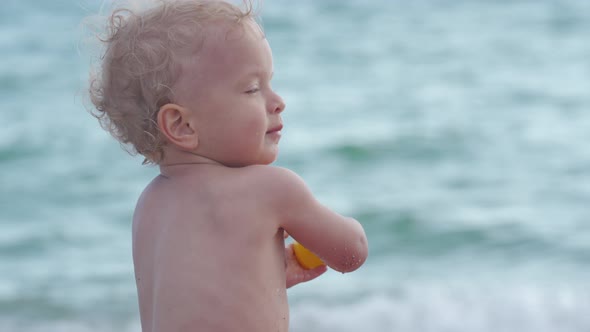 Happy Baby Boy Having Fun in Inflatable Pool for Kids on the Sea Beach Smiling Child Toddler Playing alt