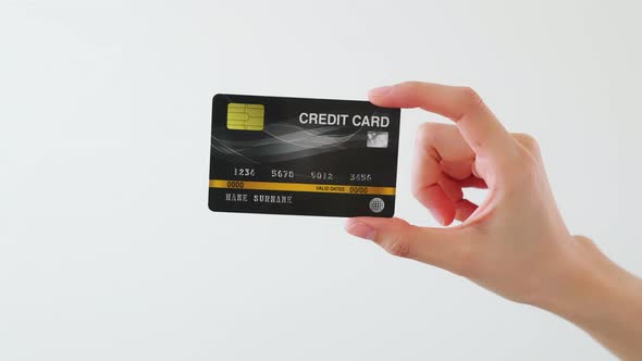 Hand holding mockup credit cards and showing on the white background. alt