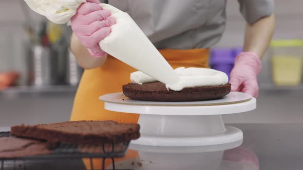 A Bright Pastry Chef Girl is Engaged in the Preparation of a Cake alt