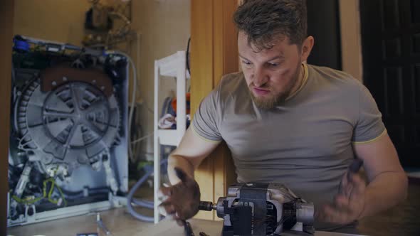 A Man Gets Angry When He Fixes a Washing Machine at Home