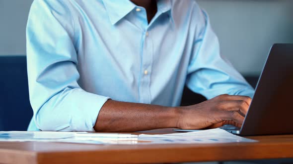 Young African American man working on laptop alt