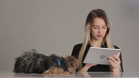 Woman with credit card shopping online on digital tablet while lying at home