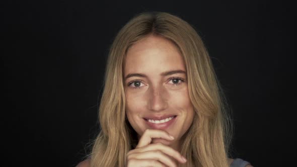 Slow motion shot of woman smiling and snapping fingers alt