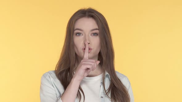 Woman showing silence, quiet gesture