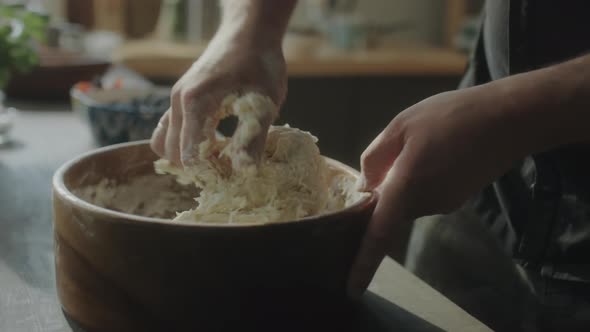 Woman Kneading Dough in Bowl alt
