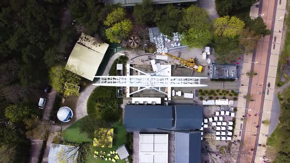 Workers building Ferris wheel in Palanga, aerial top down view alt