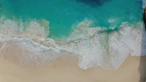 Aerial View of Wonderful Turquoise Sea Waves Lapping Along Sandy Shore alt