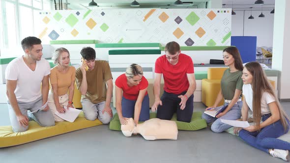 Caucasian People Practice an Exercise of Resuscitation During Lesson alt