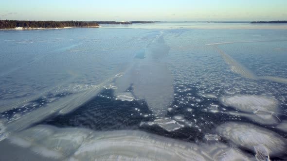 The Ray of the Sun Slowly Melting the Frozen Ice on the Water in Finland alt