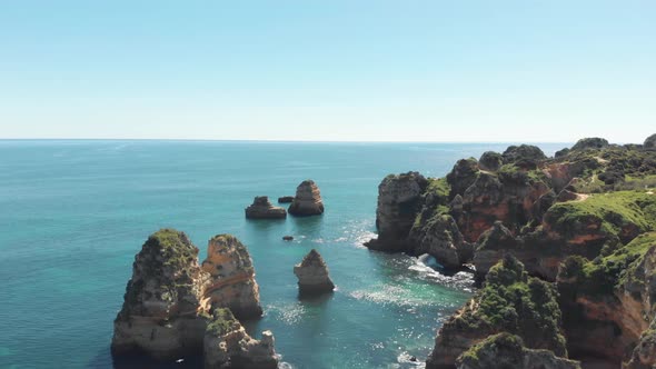 Rocky protuberances rising from the salty Algarvian sea, in Lagos coastline, Portugal alt