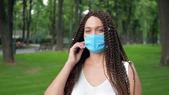 Long Curly Hair Female Take Off Protective Face Mask As Protection Against Infectious Diseases