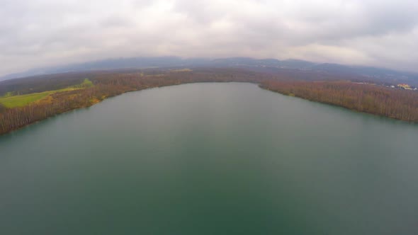 Aerial Shot of Autumn Landscape, Wide Still River, Gray Clouds in Sky on Horizon alt