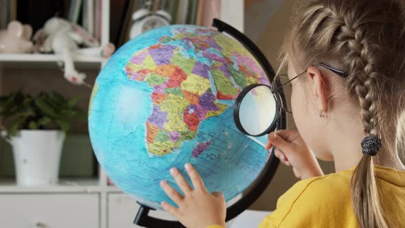 Cute Blonde Girl with a Globe