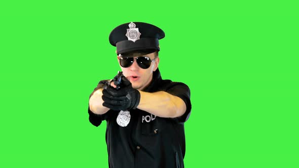 Policeman in Uniform Runs Aiming with a Gun on a Green Screen Chroma Key alt