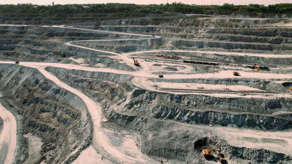 Aerial View of Opencast Mining Quarry with Lots of Machinery at Work  View From Above alt