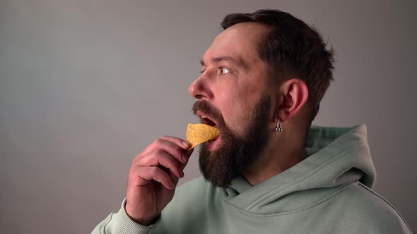 Bearded Man Eating Tortillas Chips in Slow Motion