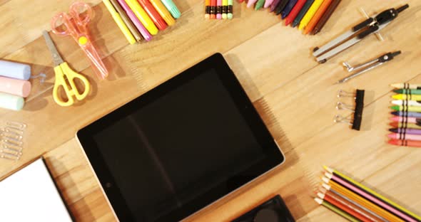 Close-up of digital tablet with various stationery alt