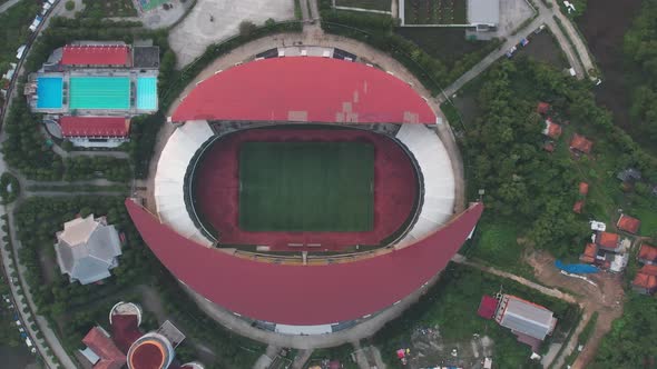 Aerial top down view of the Beautiful scenery of Wibawa Mukti Stadium when sunrise alt