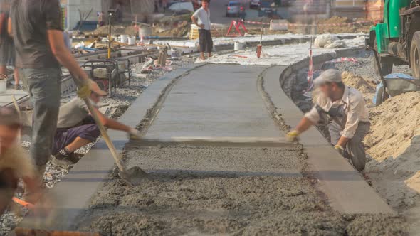 Concrete Works for Road Construction with Many Workers and Mixer Timelapse alt