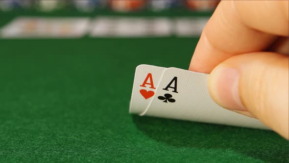 POKER: The player's hand looking his cards in the game