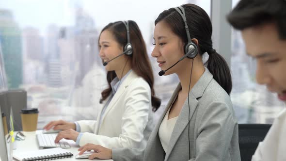 Beautiful woman Asian customer service operators talking on headsets
