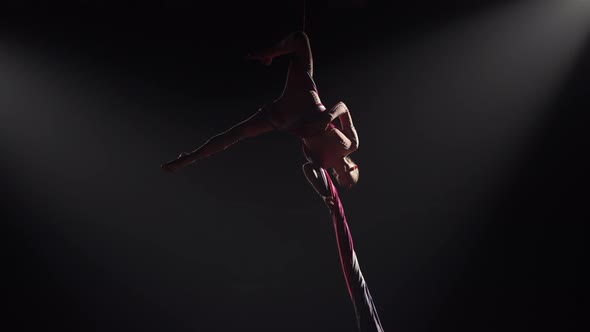 Young Female Circus Gymnast Spins on Aerial Silk and Demonstrates Stretching alt