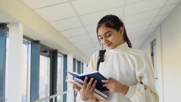 Pakistani Woman Student with a Books in the University or College alt