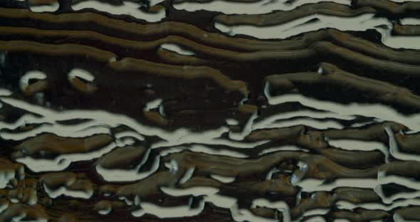 Macro shot of acrylic glass with abstract figures on it. Camera pans over the glas. alt