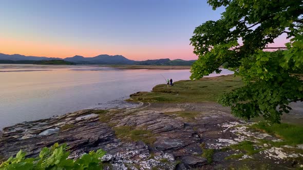 Sunset Footage of anglers fishing on the Dwyryd Estuary, Snowdonia National Park, North Wales, UK alt