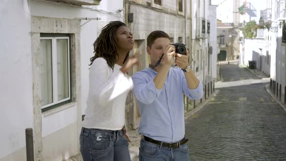 Multiethnic Couple of Tourists Standing in Old City Street alt