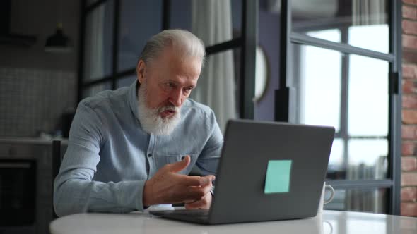 Angry Grayhaired Mature Elderly Man Having Emotionally Unpleasant Conversation Via Video Call on alt