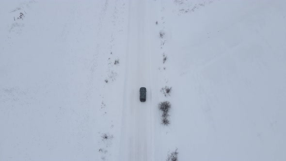 Car Driving on Road Covered With Snow