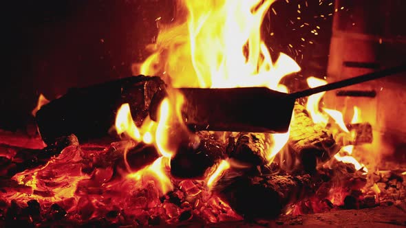 Burning Fire Poker on Black Background alt