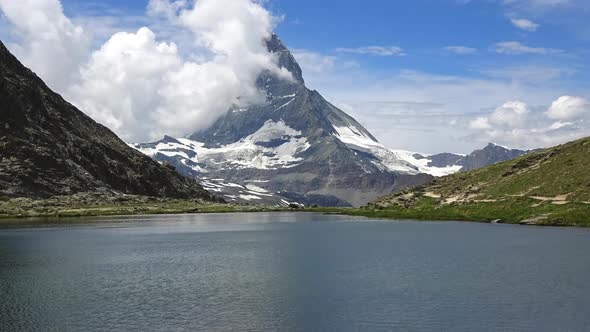 Time lapse of snowy Matterhorn peak and lake Stellisee, Swiss Alps