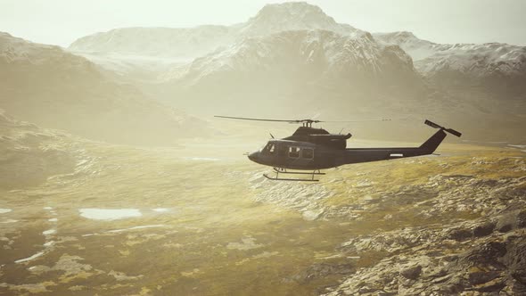 Slow Motion Vietnam War Era Helicopter in Mountains alt