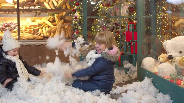 Happy Kids Playing with Artificial Snow Together