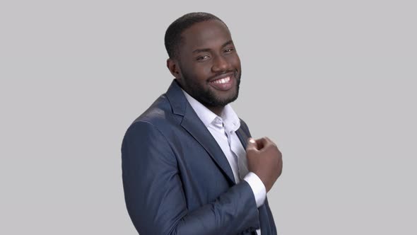 Joyful Macho-man on Grey Background. alt