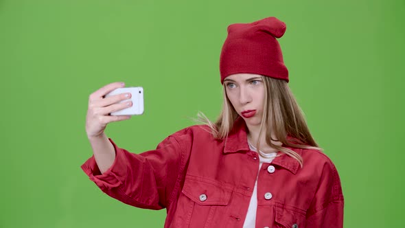 Teenager Makes Selfie with Different Emotions. Green Screen. Slow Motion alt