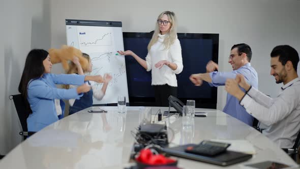 Dazed Serious Caucasian Businesswoman in Eyeglasses Presenting Plan in Office As Coworkers Dancing alt