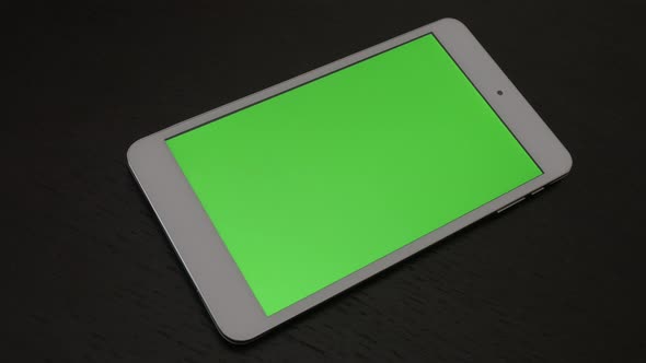Green screen display on silver PC tablet slow panning 4K 3840X2160 UHD video - Tablet PC with greens alt