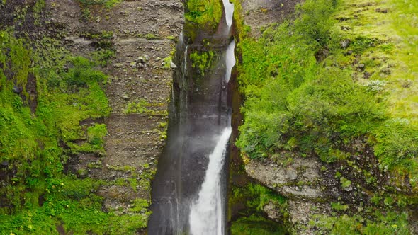 Water Falling Flowing Down Beautiful Vibrant Green Cascade. alt
