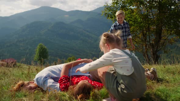 Happy Family Lying Piled on Each Other Close Up alt