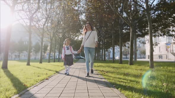 Mother and Little Daughter in Uniform Going To School at Morning, Steadicam alt