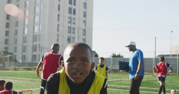 African American soccer kid exercising in a sunny day alt