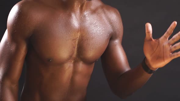 An Athletic AfricanAmerican in Good Athletic Shape is Engaged in Sports on an Isolated Dark alt